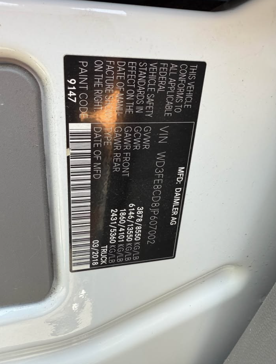 Vehicle identification label on a car's white surface