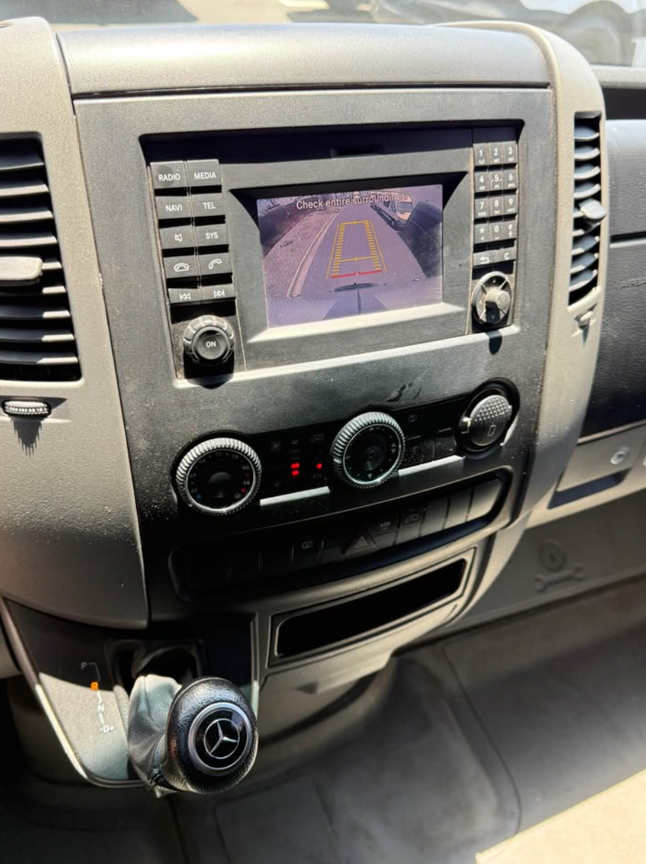 Car dashboard with navigation screen and Mercedes-Benz logo