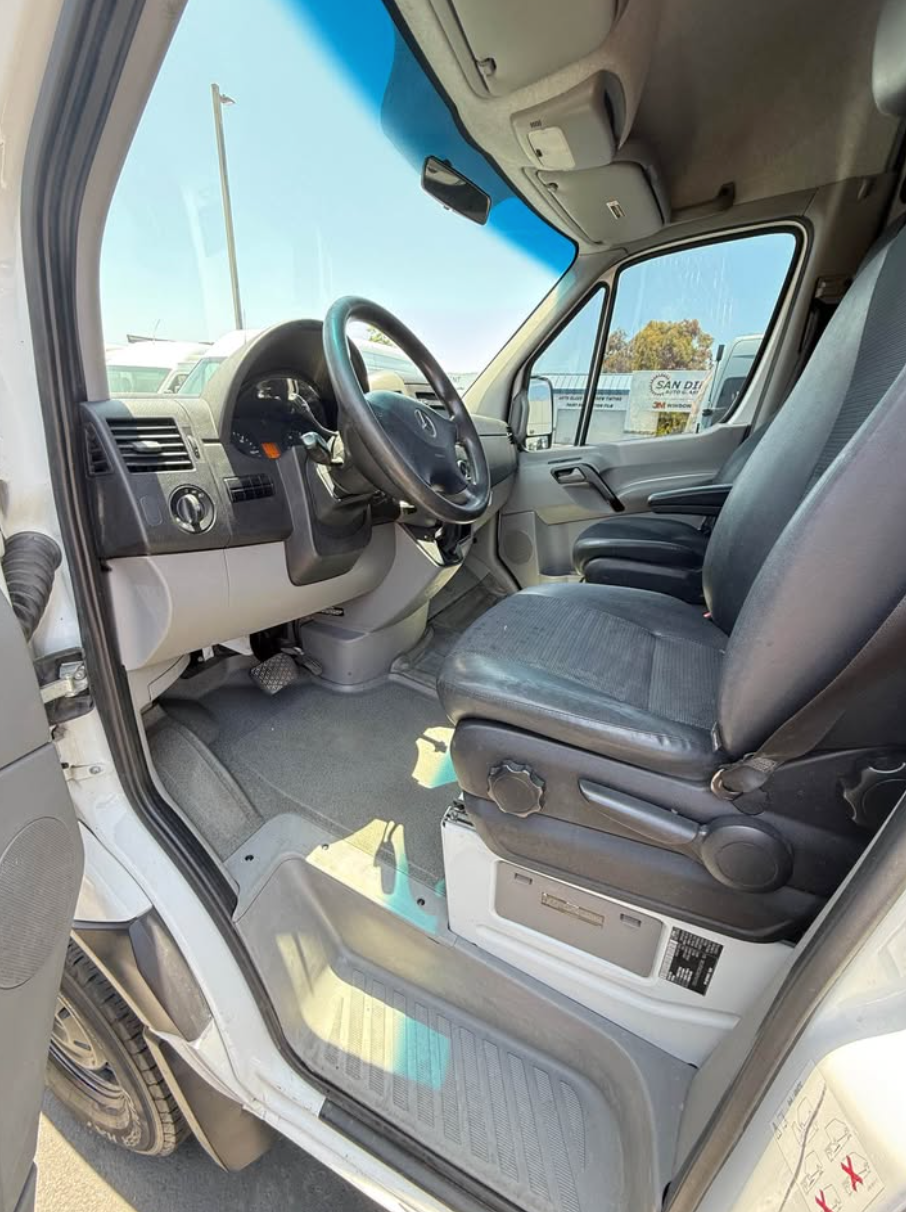 Interior of a vehicle with steering wheel and dashboard visible